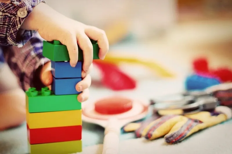 A child is stacking toy blocks.